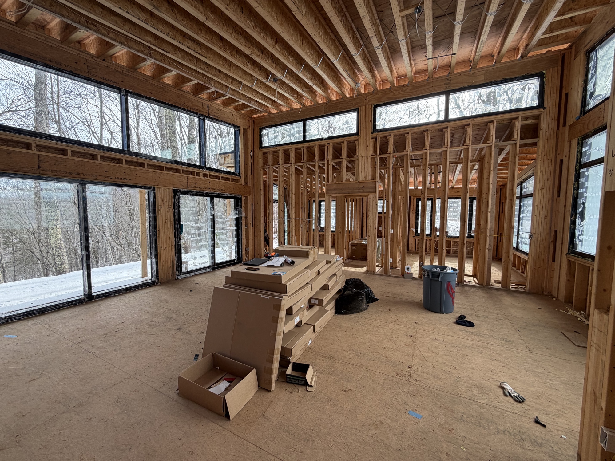 New home under construction, framed interior with large windows and mountain views